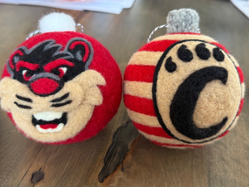 UC striped ornamnet with the UC monogram