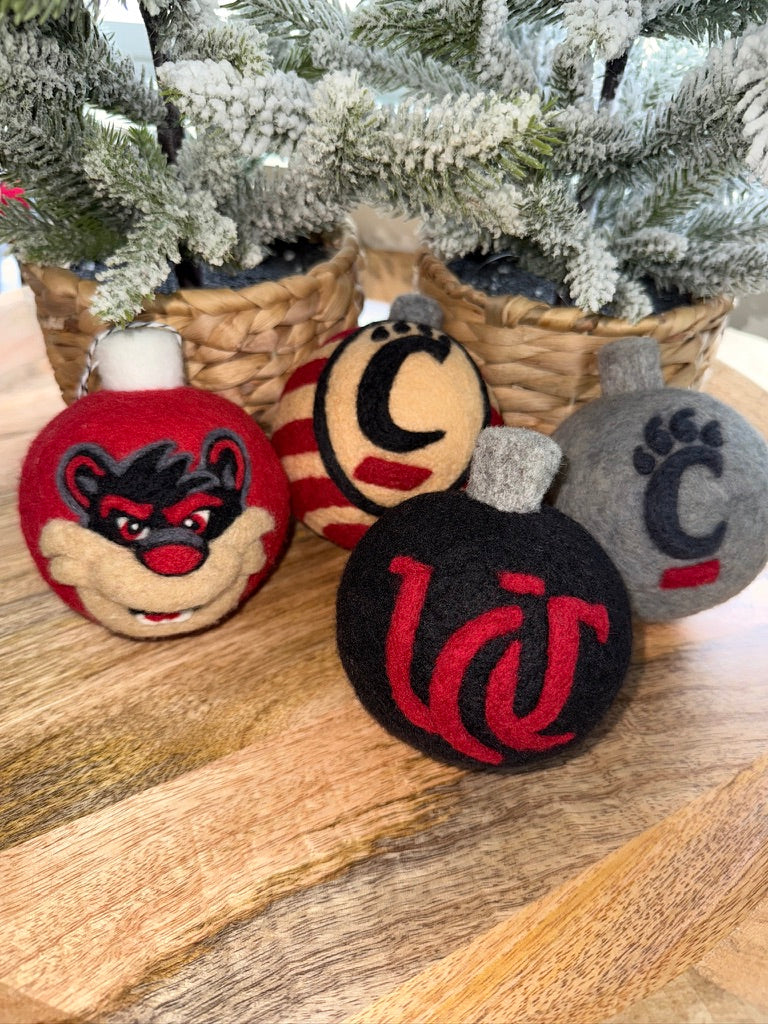 UC Grey ornamnet with 2-D Bearcat on one side and pawprint on the other