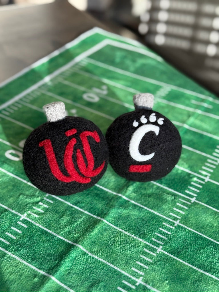 UC Black ornamnet with the UC monogram on one side and pawprint on the other