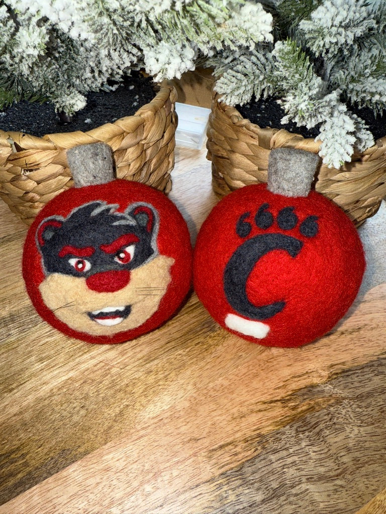UC Red ornamnet with 2-D Bearcat on one side and pawprint on the other