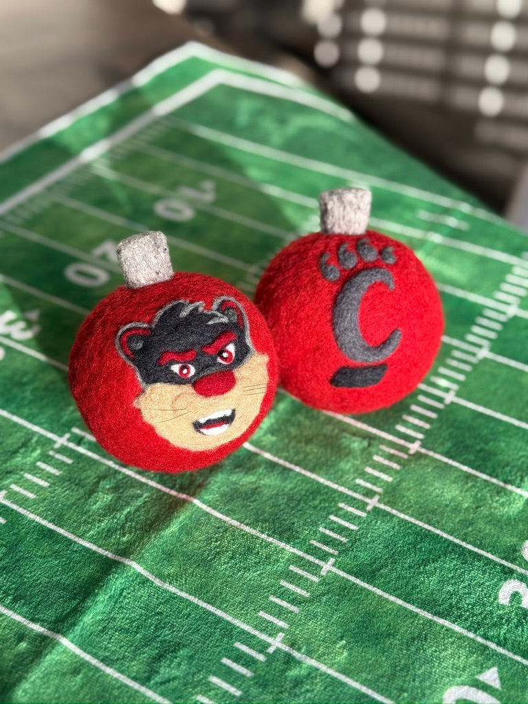 UC Red ornamnet with 2-D Bearcat on one side and pawprint on the other